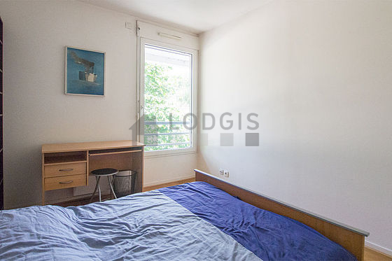 Bright bedroom equipped with desk, wardrobe, cupboard, stool
