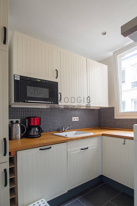 Cuisine équipée de lave vaisselle, plaques de cuisson, réfrigerateur, hotte