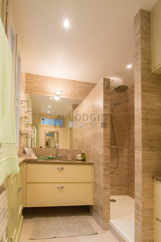 Bathroom equipped with washing machine, dryer, bath towels