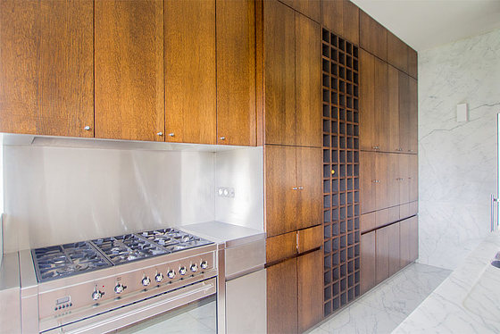 Kitchen equipped with dishwasher, hob, refrigerator, extractor hood