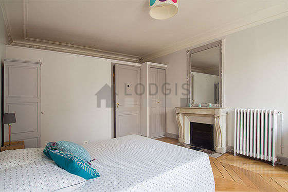 Bright bedroom equipped with closet, storage space, cupboard, bedside table