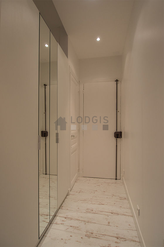 Beautiful entrance with wooden floor and equipped with washing machine