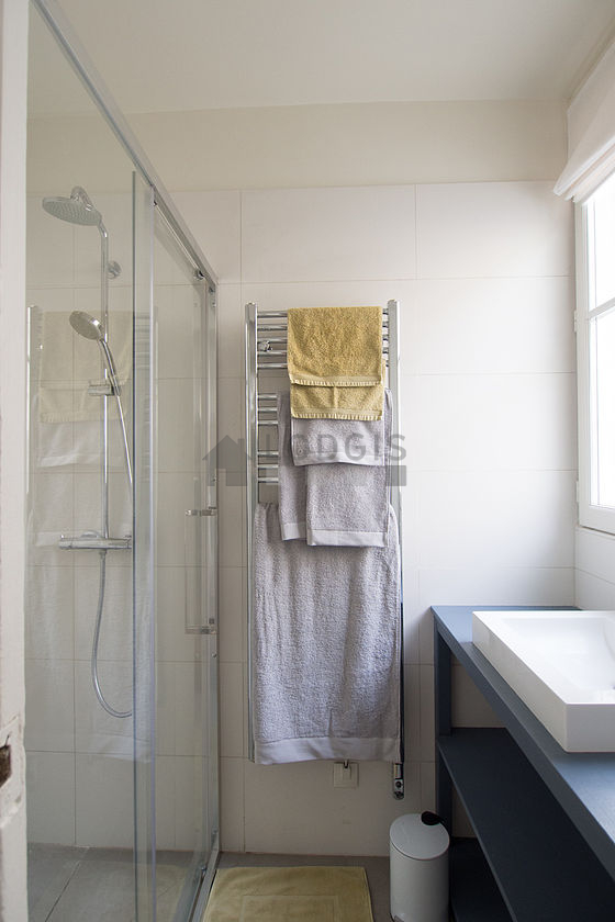 Bathroom equipped with washing machine, bath towels