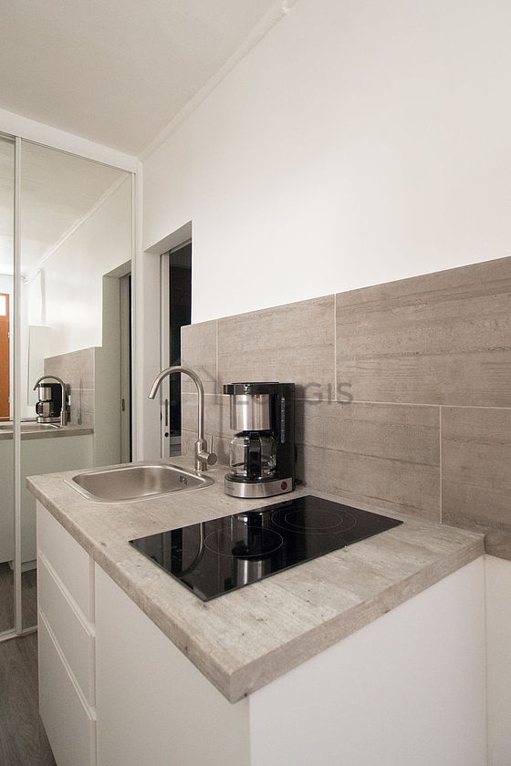 Kitchen equipped with hob, refrigerator, freezer, crockery