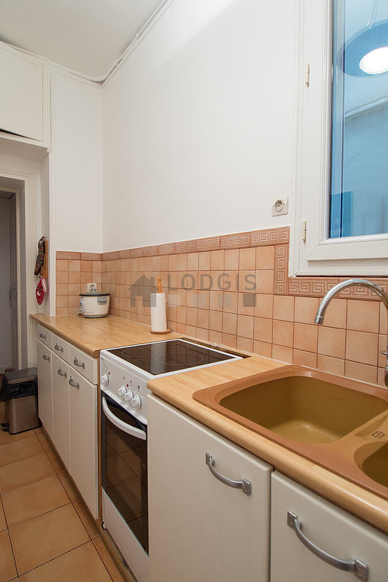 Kitchen equipped with washing machine, refrigerator, crockery