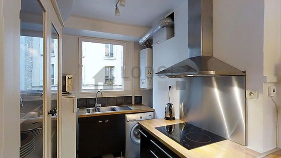 Kitchen equipped with washing machine, refrigerator, extractor hood