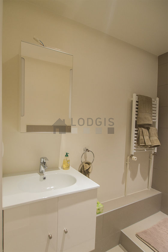 Bathroom equipped with washing machine, bath towels