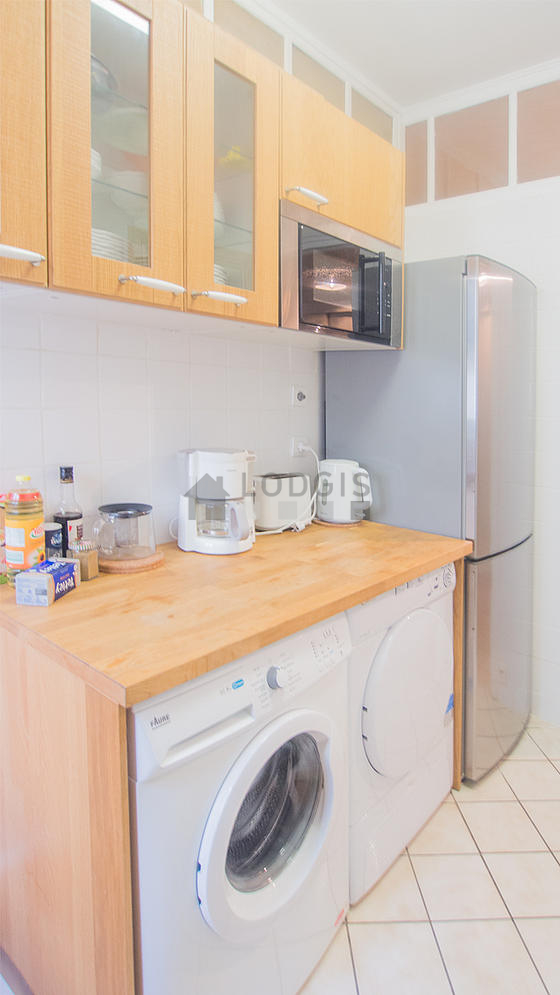Kitchen equipped with washing machine, dryer, refrigerator, extractor hood