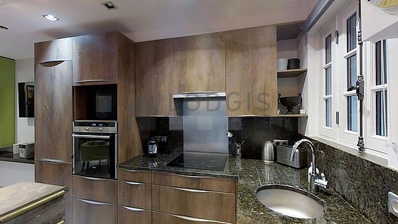 Kitchen equipped with dishwasher, hob, refrigerator, extractor hood