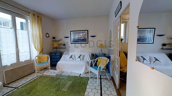 Quiet living room furnished with tv, storage space, 6 chair(s)