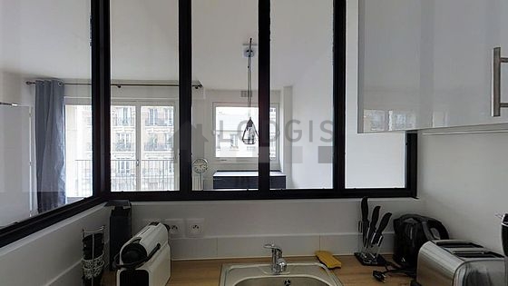 Kitchen equipped with dishwasher, hob, refrigerator, crockery