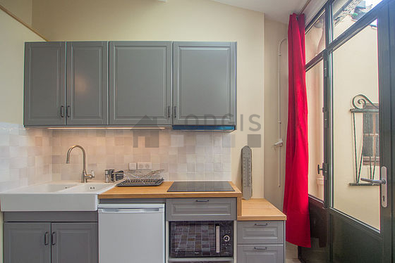 Kitchen equipped with washing machine, refrigerator, extractor hood, crockery