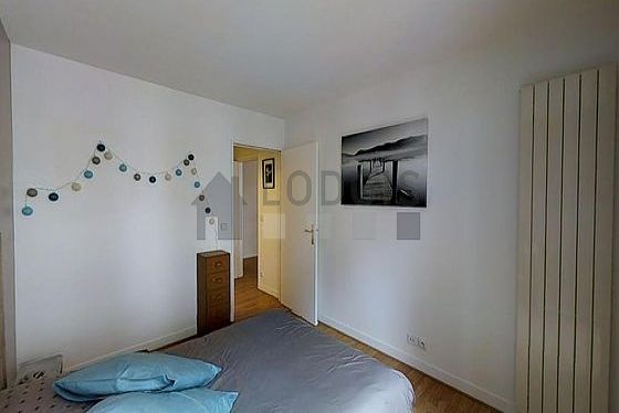 Very bright bedroom equipped with storage space, bedside table