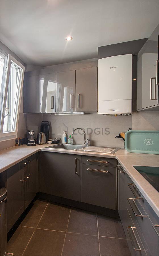 Kitchen equipped with dishwasher, hob, refrigerator, extractor hood