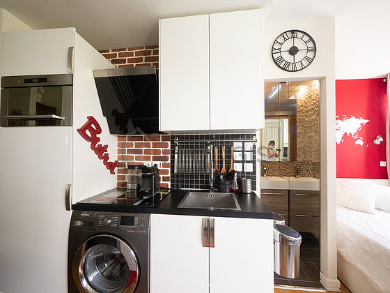 Kitchen where you can have dinner for 2 person(s) equipped with washing machine, refrigerator, extractor hood, crockery