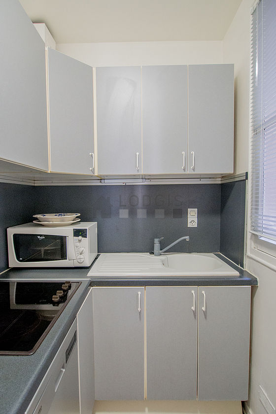 Kitchen equipped with dishwasher, hob, refrigerator, extractor hood