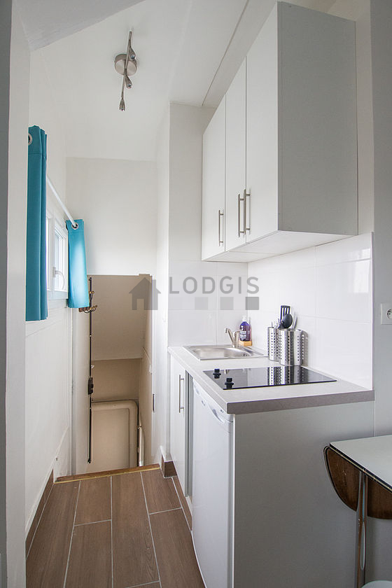 Kitchen equipped with hob, refrigerator, freezer, crockery
