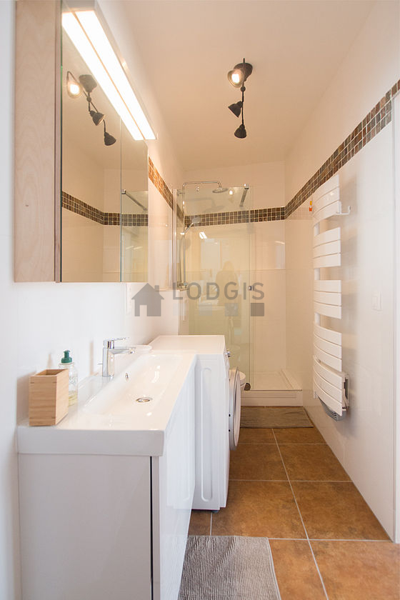 Bathroom equipped with washing machine, bath towels