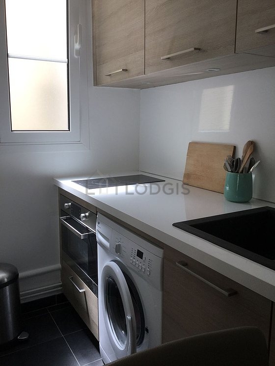 Kitchen equipped with washing machine, refrigerator, freezer, crockery