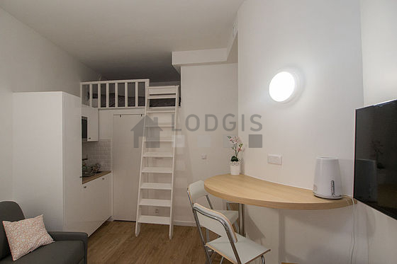 Living room furnished with tv, storage space
