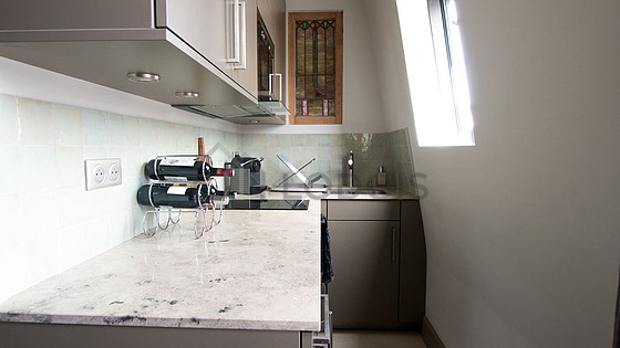 Beautiful kitchenopens on the living room with tile floor