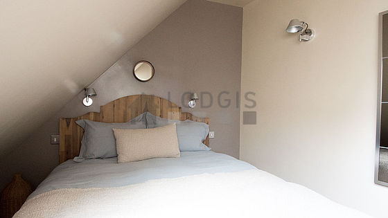 Bright bedroom equipped with 1 armchair(s), stool