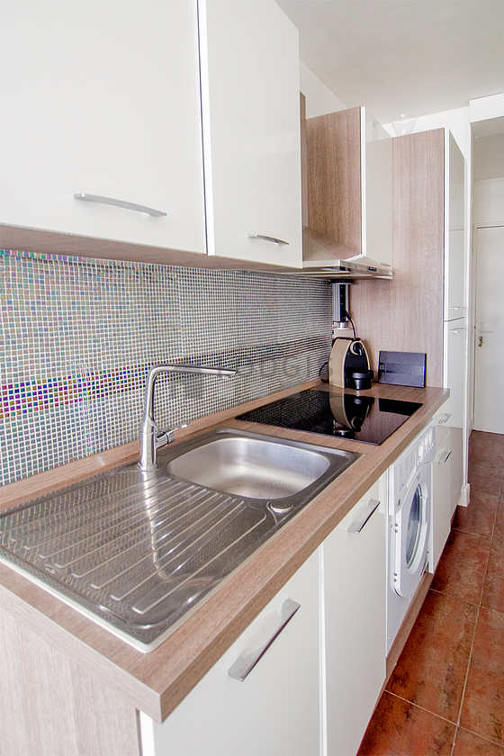 Kitchen equipped with washing machine, refrigerator, freezer, crockery