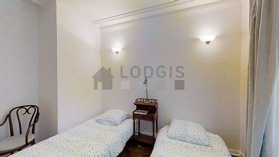 Bright bedroom equipped with wardrobe, bedside table