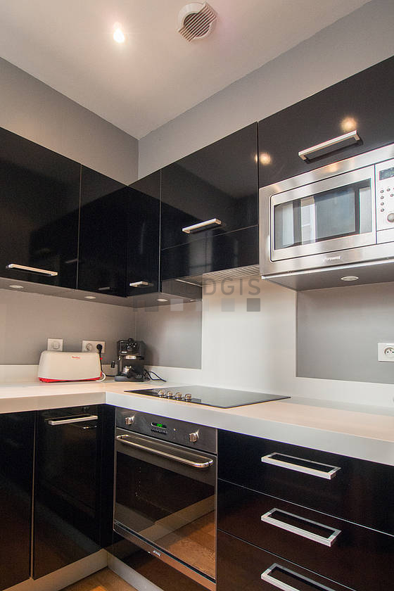 Kitchen equipped with hob, refrigerator, freezer, extractor hood