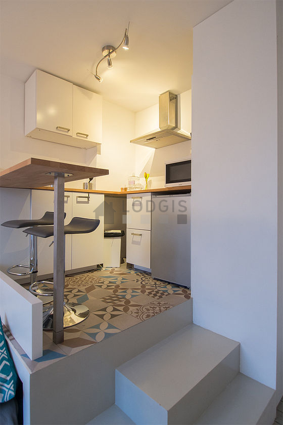 Kitchen where you can have dinner for 2 person(s) equipped with hob, refrigerator, freezer, extractor hood