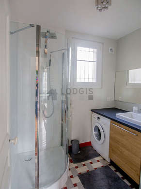 Bathroom equipped with washing machine, dryer, bath towels