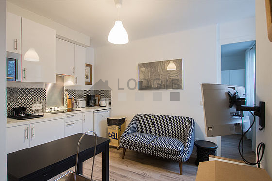 Very quiet living room furnished with tv, cupboard
