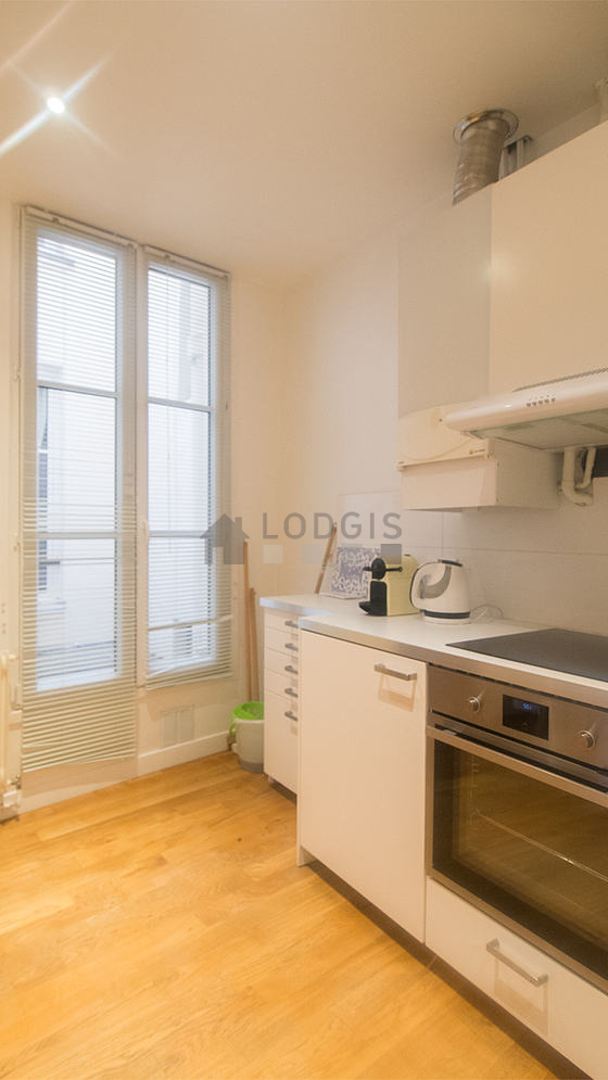 Kitchen equipped with washing machine, refrigerator, extractor hood, crockery