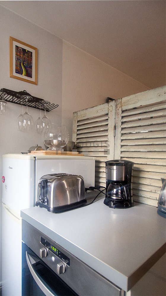 Kitchen equipped with dishwasher, hob, refrigerator, crockery