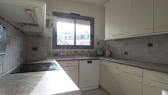 Kitchen equipped with dishwasher, hob, refrigerator, extractor hood