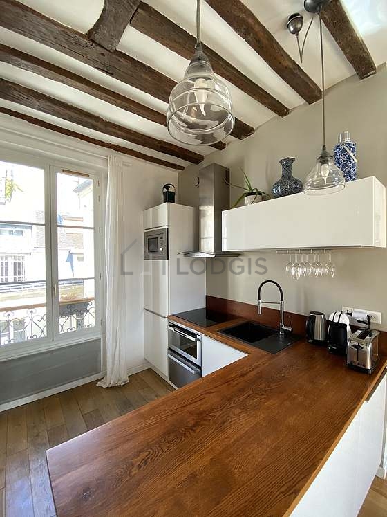 Kitchen equipped with washing machine, refrigerator, freezer, crockery