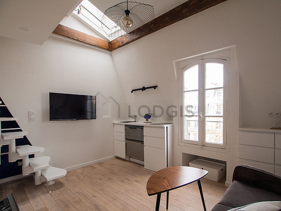 Quiet living room furnished with tv, fan