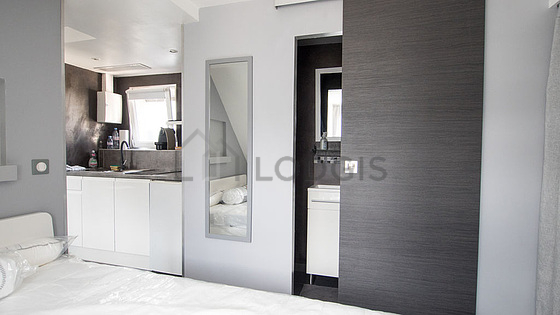 Bright bedroom equipped with air conditioning, wardrobe, cupboard