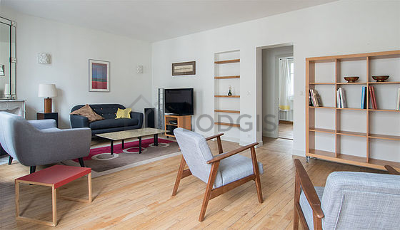 Quiet living room furnished with tv, 2 armchair(s)