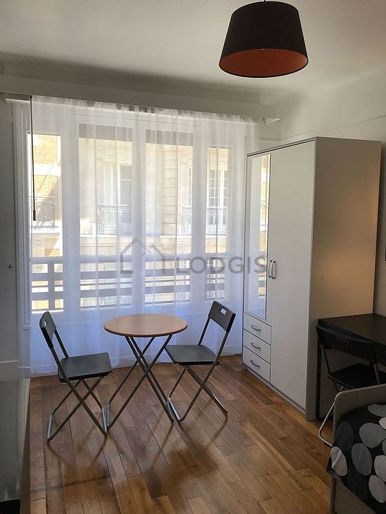 Quiet living room furnished with dining table, closet, storage space, 2 chair(s)