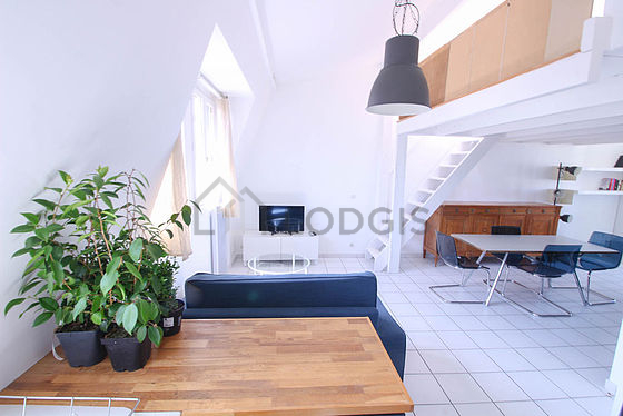 Grand salon de 30m² avec du carrelage au sol