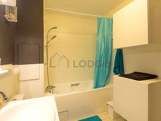 Bathroom equipped with washing machine, dryer, shelves