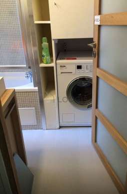 Bathroom equipped with washing machine, shelves