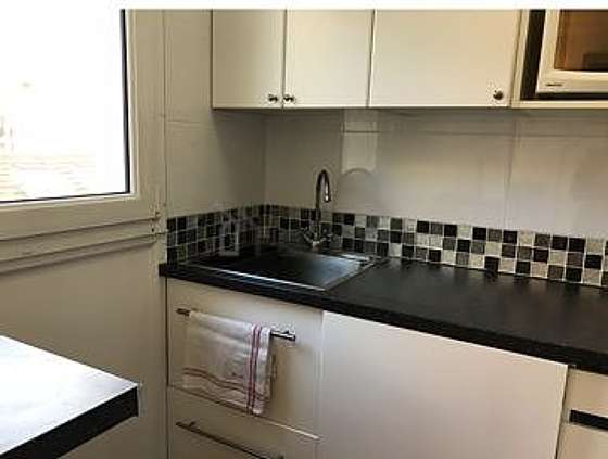 Kitchen equipped with washing machine, refrigerator, freezer, extractor hood