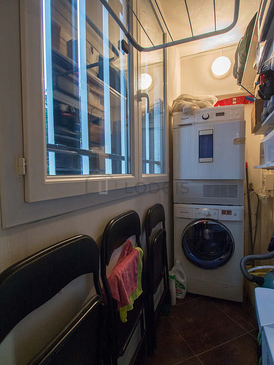 Beautiful laundry room with tile floor and equipped with washing machine, dryer, 1 chair(s)