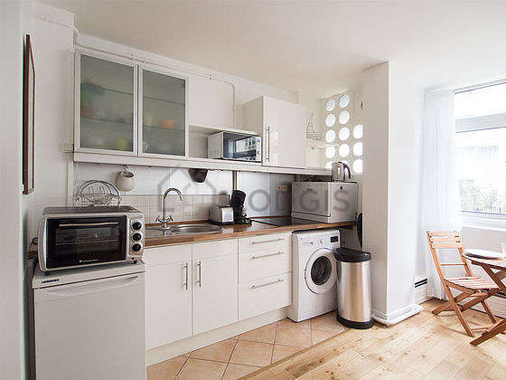 Kitchen where you can have dinner for 4 person(s) equipped with washing machine, refrigerator, crockery