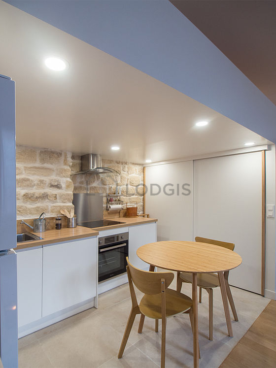 Kitchen where you can have dinner for 2 person(s) equipped with washing machine, refrigerator, extractor hood, crockery