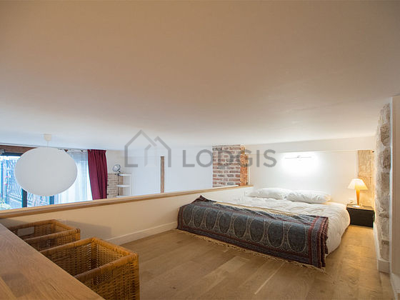 Mezzanine with a high ceiling with wooden floor