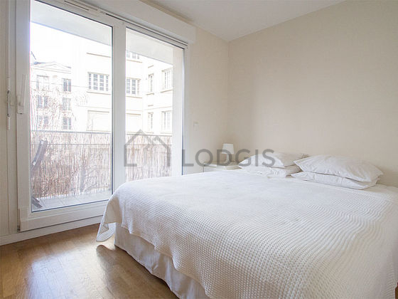 Very bright bedroom equipped with 1 armchair(s), bedside table
