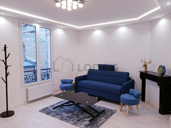 Very quiet living room furnished with tv, 1 armchair(s), 1 chair(s)